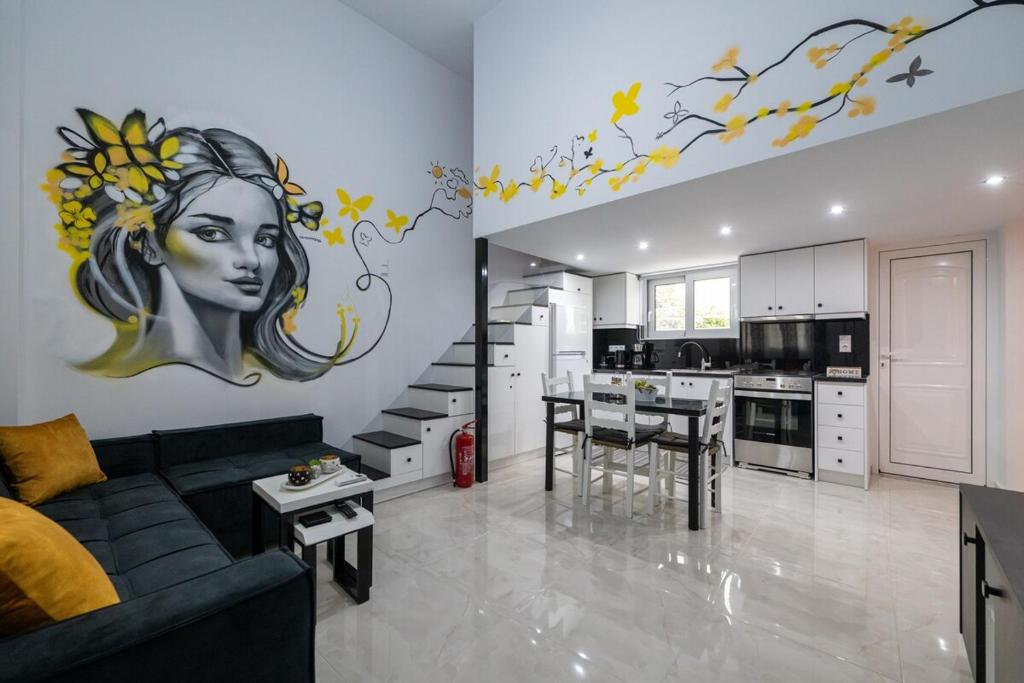 a living room with a black couch and a kitchen at Sophia's Apartment in Kalamata