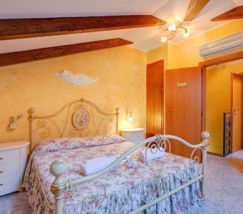a bedroom with a white bed in a room at Villa Caterina in San Bartolomeo al Mare