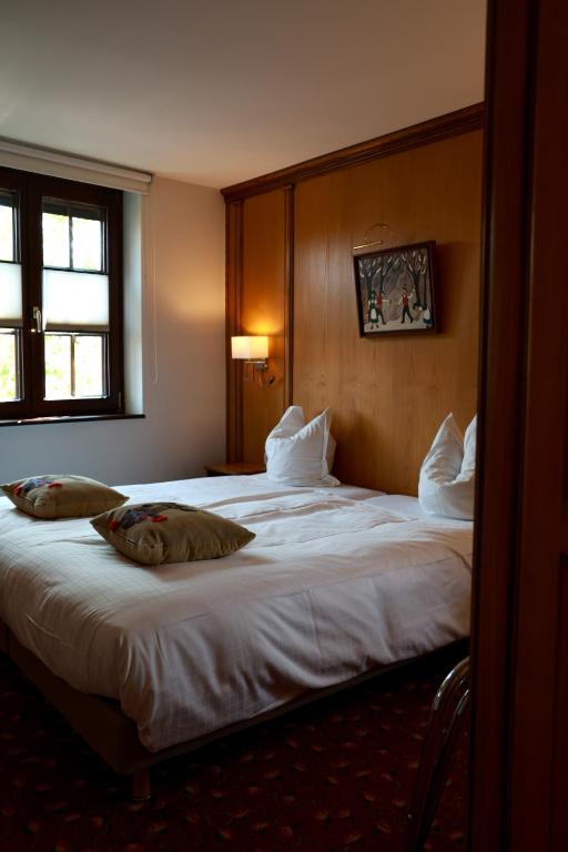 Postel nebo postele na pokoji v ubytování Hotel - Restaurant Le Cerf & Spa