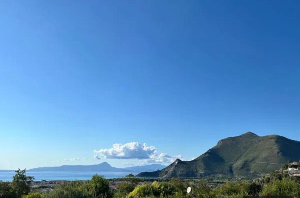 a view of the ocean and mountains with a blue sky at A Casa di Laura in Praia a Mare