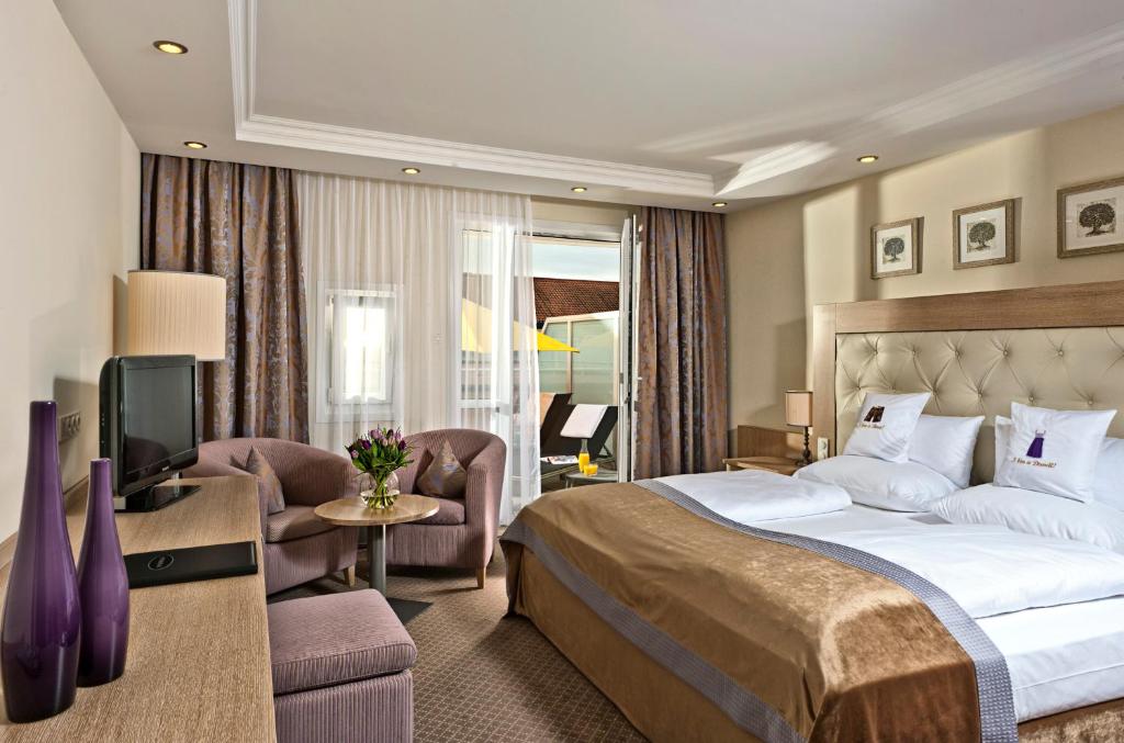 Postel nebo postele na pokoji v ubytování Hotel Maximilian