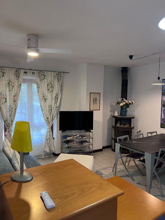 a living room with a tv and a table at Agriturismo Buranco in Monterosso al Mare