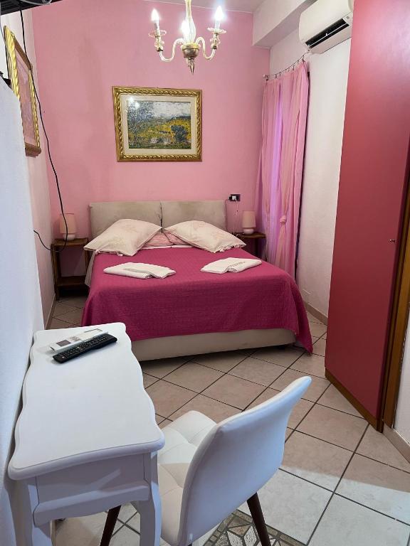 a bedroom with a bed and a table and a chair at Agriturismo Buranco in Monterosso al Mare