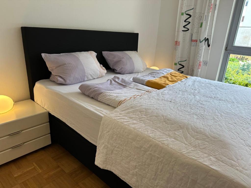 a bed with two pillows on it in a bedroom at Loft mit Terrasse und Schlafzimmer in Neumarkt in der Oberpfalz