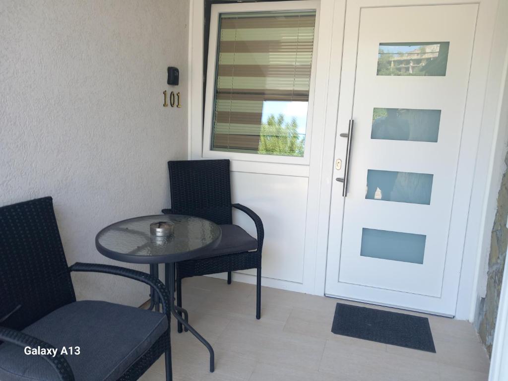 a small table and chairs next to a door at Sarajevo apartman Ilidza Springs parking free in Sarajevo