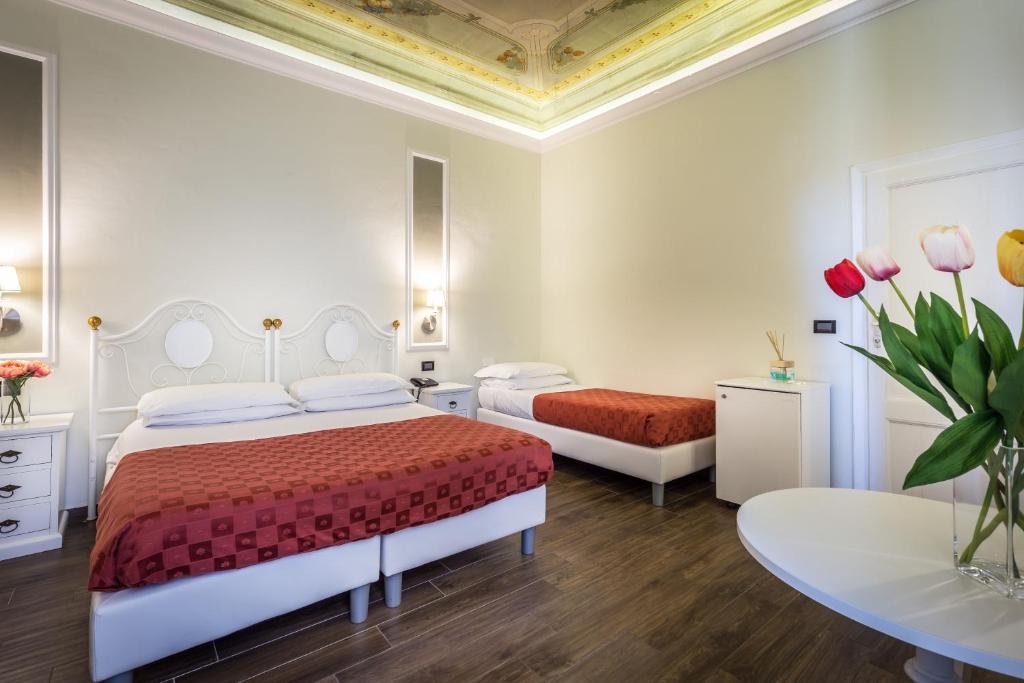 Postel nebo postele na pokoji v ubytování Hotel Ferrucci