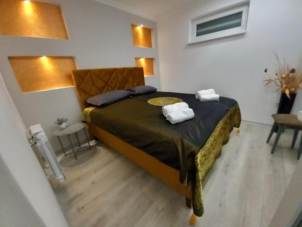 a bedroom with a bed with two towels on it at Sarajevo apartman Ilidza Springs parking free in Sarajevo