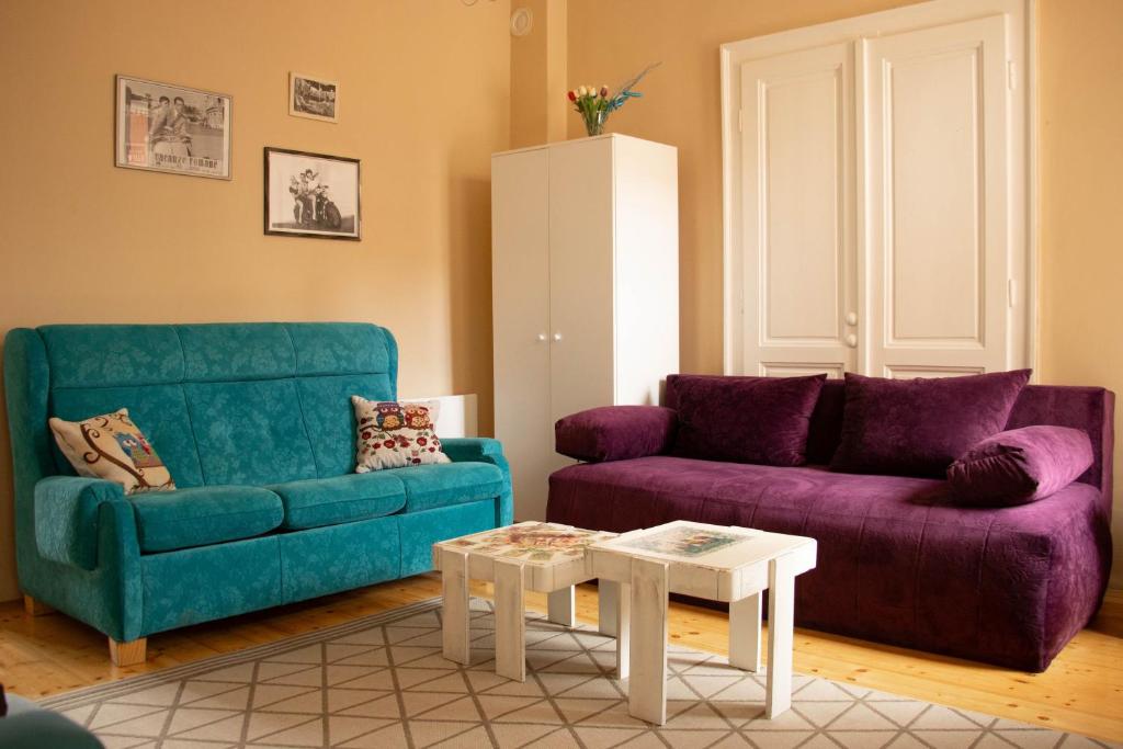 a living room with a couch and a table at Apartment By the River in Niš