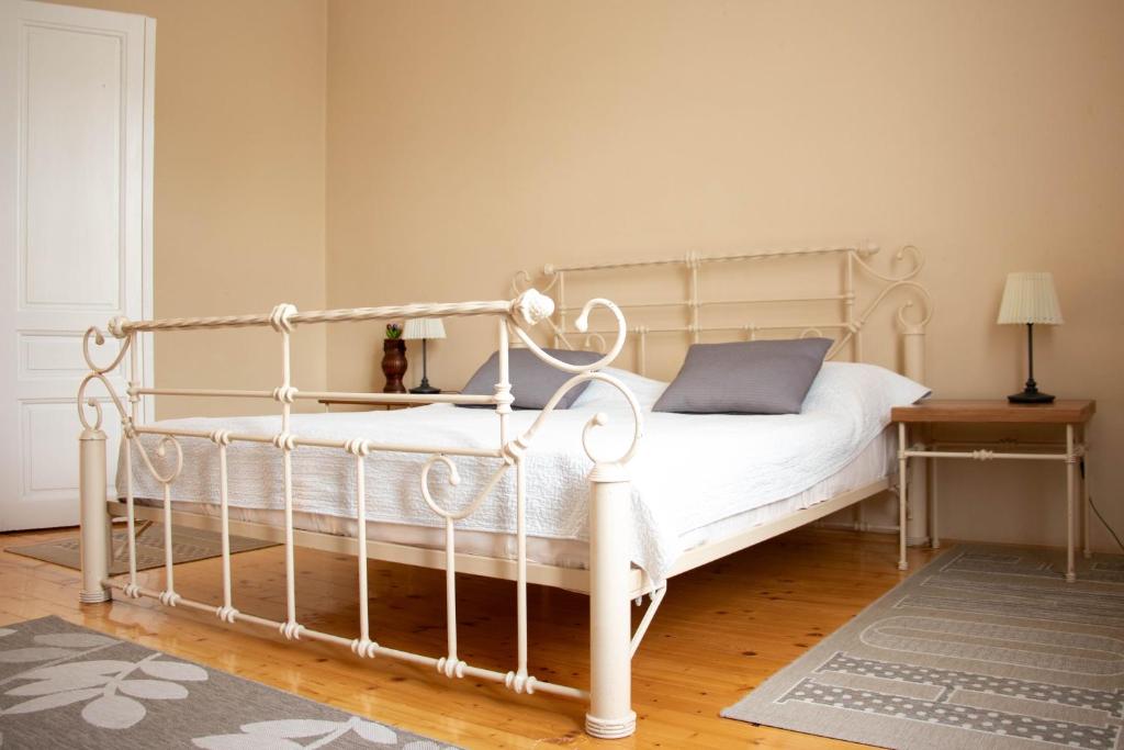 a bedroom with a white bed and a table at Apartment By the River in Niš
