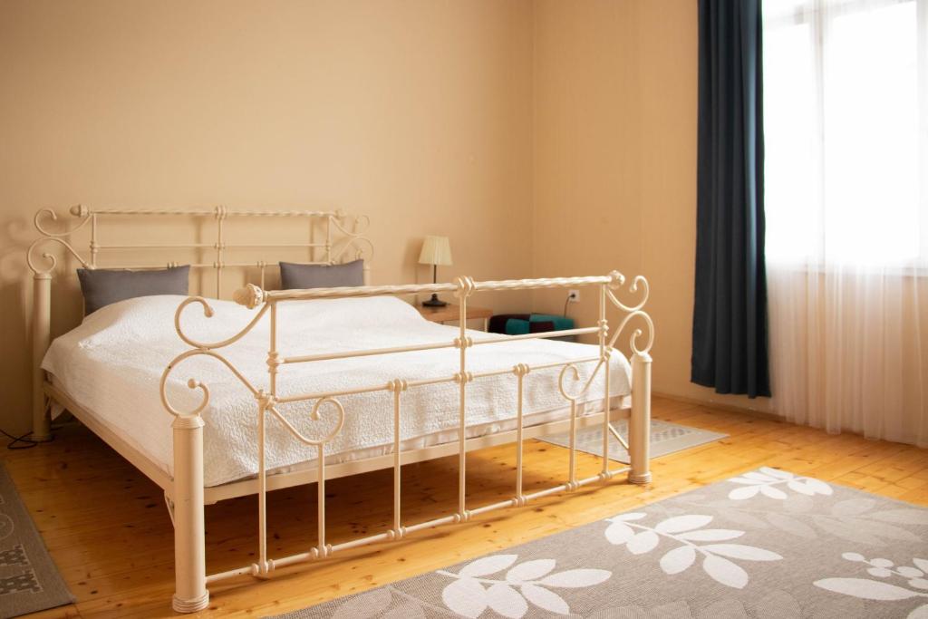 a bedroom with a white bed in a room at Apartment By the River in Niš
