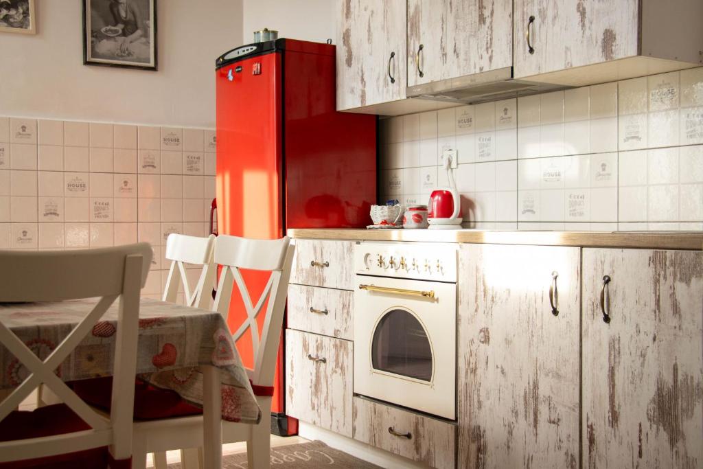 a kitchen with a red refrigerator and a stove at Apartment By the River in Niš