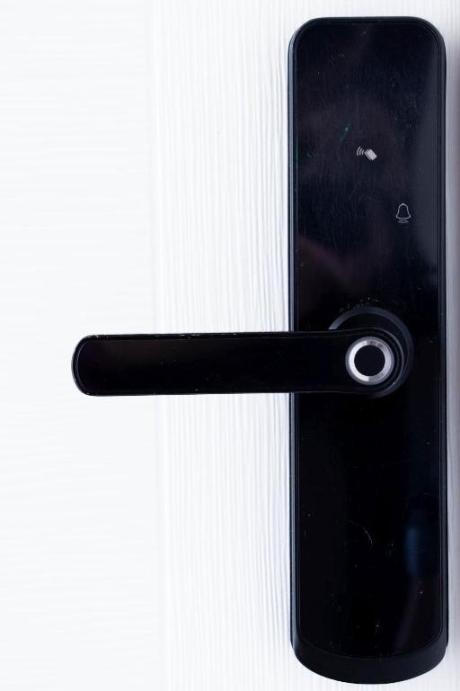 a black door handle of a cell phone at Apartment By the River in Niš