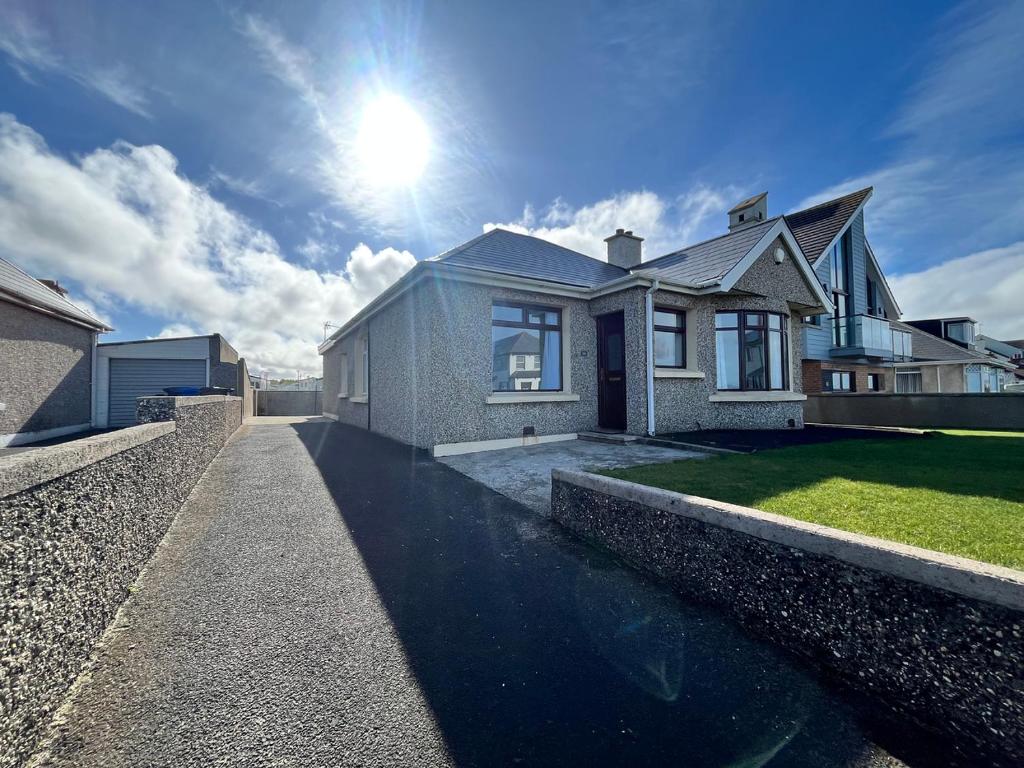 a house with a pool in front of it at Portrush Seaview Beach House in Portrush