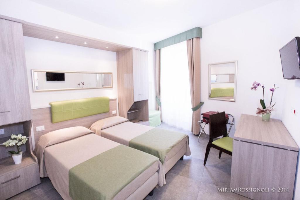 a hotel room with two beds and a television at La Casa di Zuecca in Monterosso al Mare