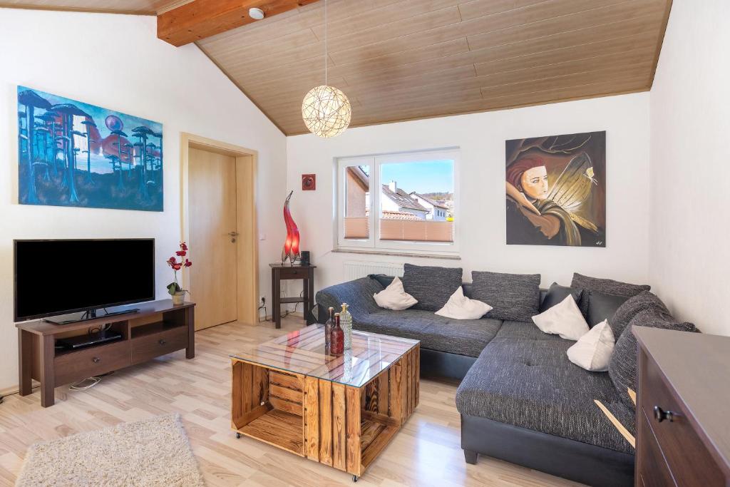 Télévision ou salle de divertissement dans l'établissement Ferienwohnung Beni