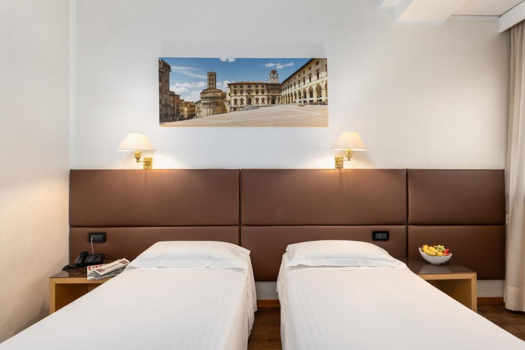 Postel nebo postele na pokoji v ubytování Hotel Minerva