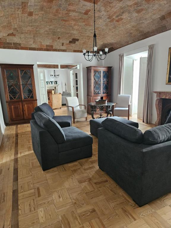 a living room with two couches and a fireplace at Solar de Arrayollos by PURUS in Arraiolos