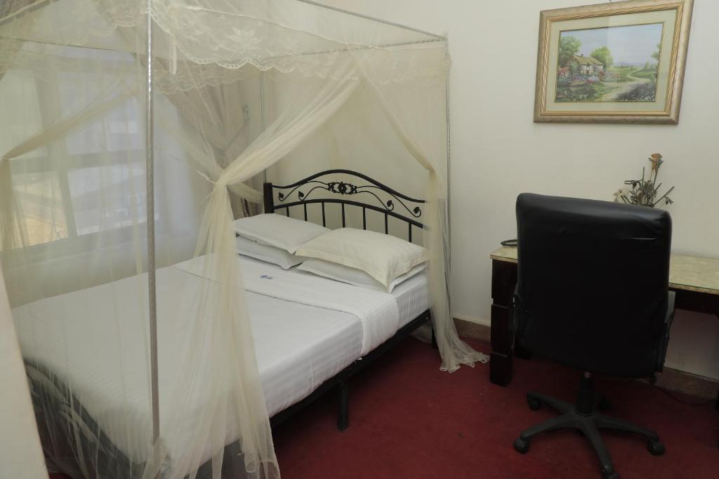 Postel nebo postele na pokoji v ubytování EXCELLENT HOTEL KAMPAlA