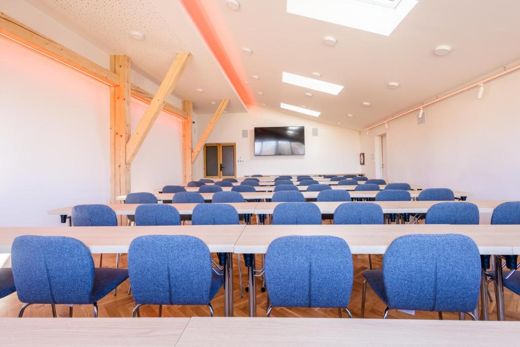 a conference room with a large table and chairs at Retro Hotel JISKRA in Čeladná