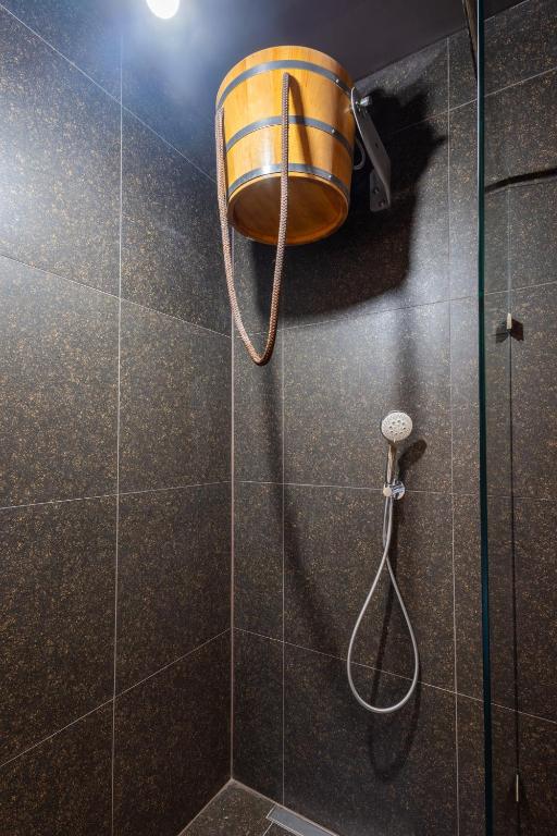 a shower with a bucket on the wall at Retro Hotel JISKRA in Čeladná