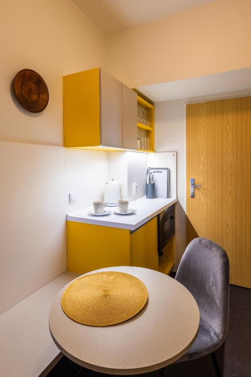 a small kitchen with a table and a counter top at Retro Hotel JISKRA in Čeladná