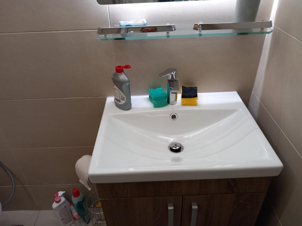 a white sink in a bathroom with a shower at Sarajevo apartman Ilidza Springs parking free in Sarajevo