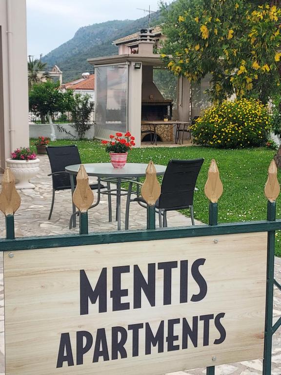 a sign that reads merritarius apartments with chairs and a table at ΔΙΑΜΈΡΙΣΜΑ ΜΕΝΤΗΣ in Igoumenitsa