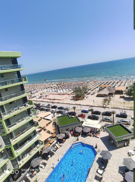 a resort with a pool and a beach with umbrellas at Alezi Apartamente in Mamaia Sat/Năvodari