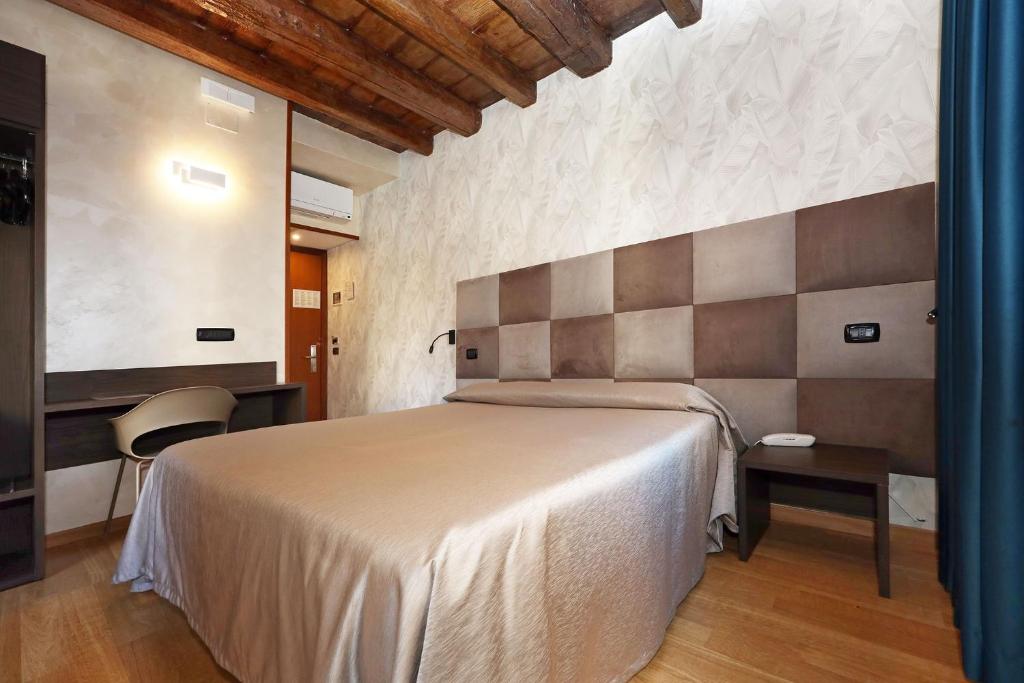 Postel nebo postele na pokoji v ubytování Hotel Rimini
