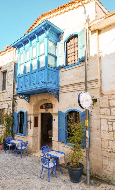 a building with a blue balcony on top of it at Mai Alaçatı in Çeşme