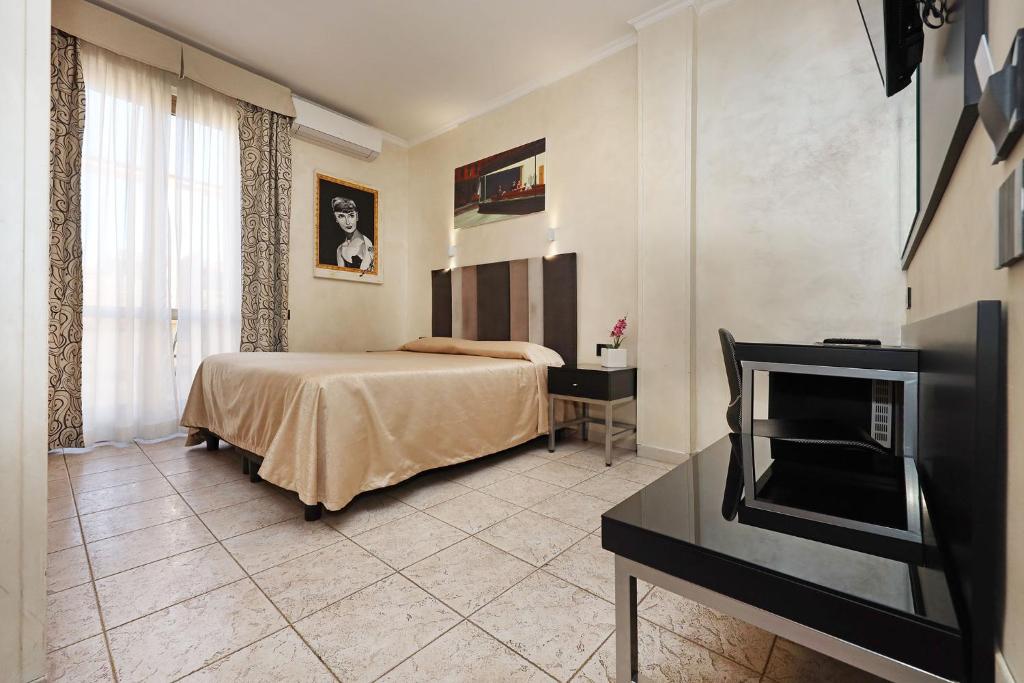 Postel nebo postele na pokoji v ubytování Hotel Rimini