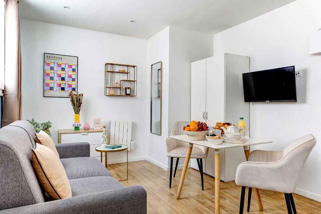 un salon avec un canapé et une table dans l'établissement Studio Cosy au coeur de Paris pres des Buttes-Chaum, à Paris
