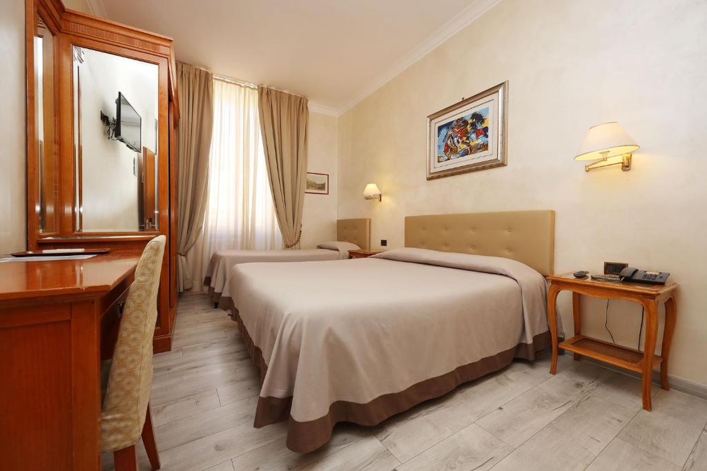 Postel nebo postele na pokoji v ubytování Hotel Rimini