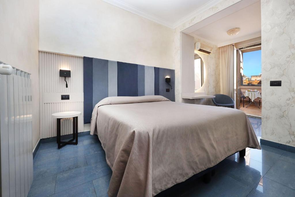 Postel nebo postele na pokoji v ubytování Hotel Rimini