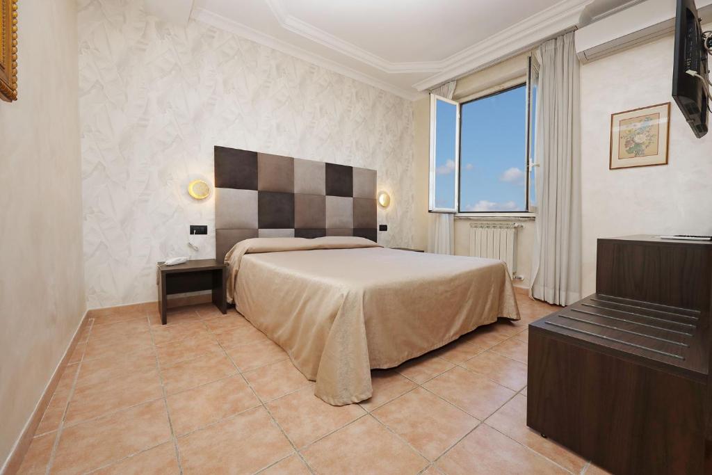 Postel nebo postele na pokoji v ubytování Hotel Rimini