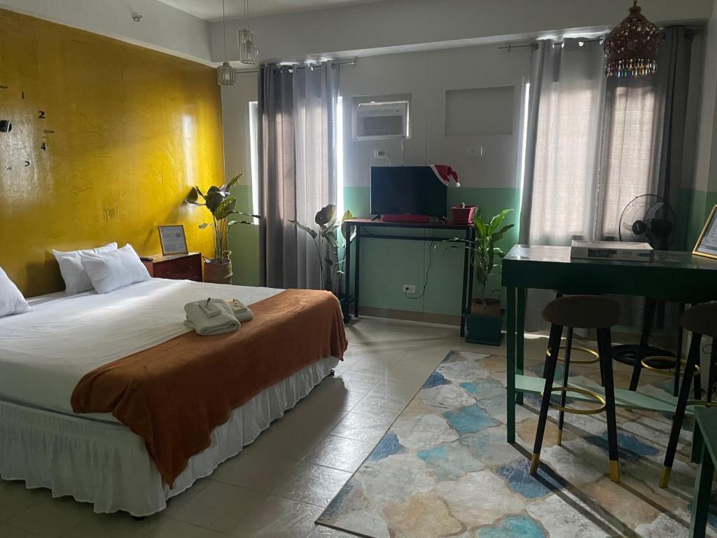 a bedroom with a bed and a desk in it at Poolside Apartment - Sleeps 4 Ac & Hot Shower in Marilao