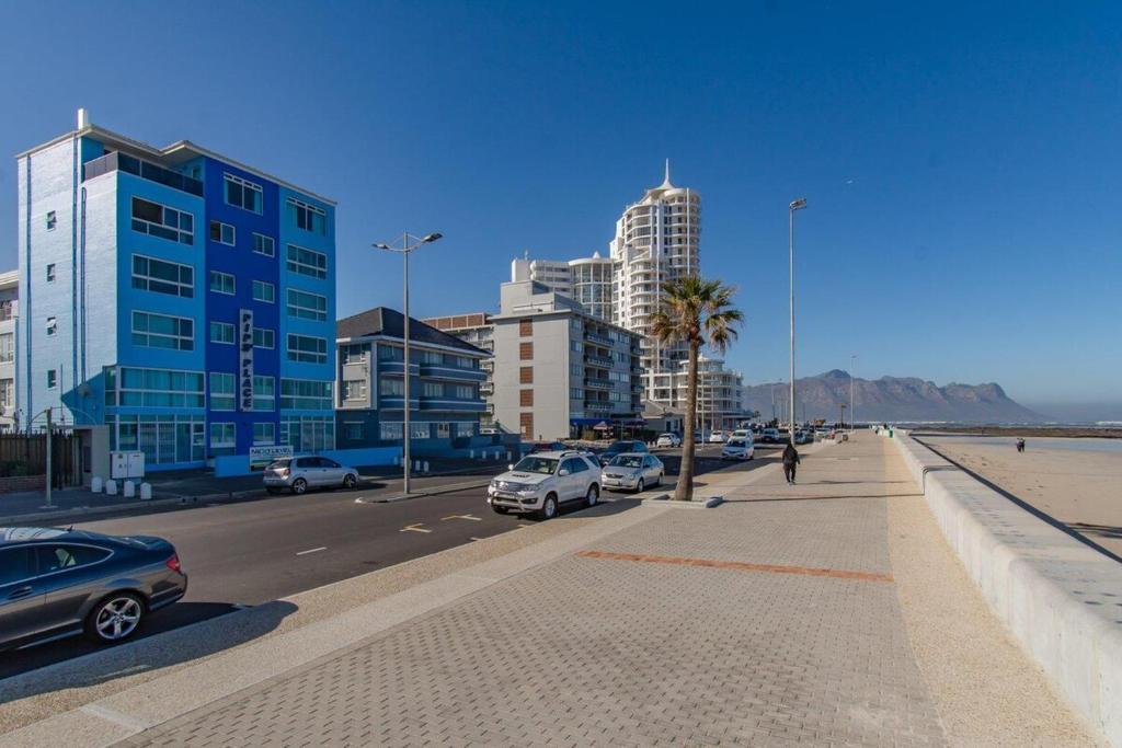 a city with cars parked on a street with buildings at Pips Place 203 in Strand