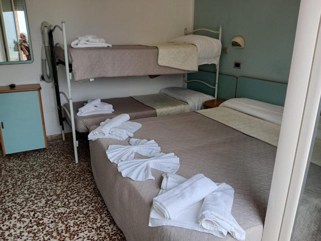 Postel nebo postele na pokoji v ubytování Hotel Golino