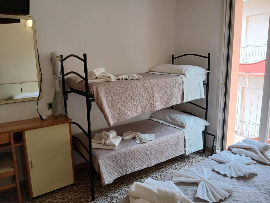 Postel nebo postele na pokoji v ubytování Hotel Golino