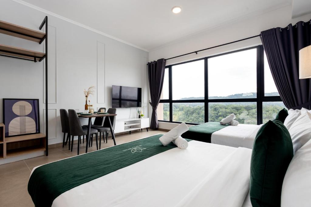 two beds in a room with a table and a dining room at 9 Mossaz skypool 5mins to 1U and Ikea atEmpire City by Light House in Petaling Jaya