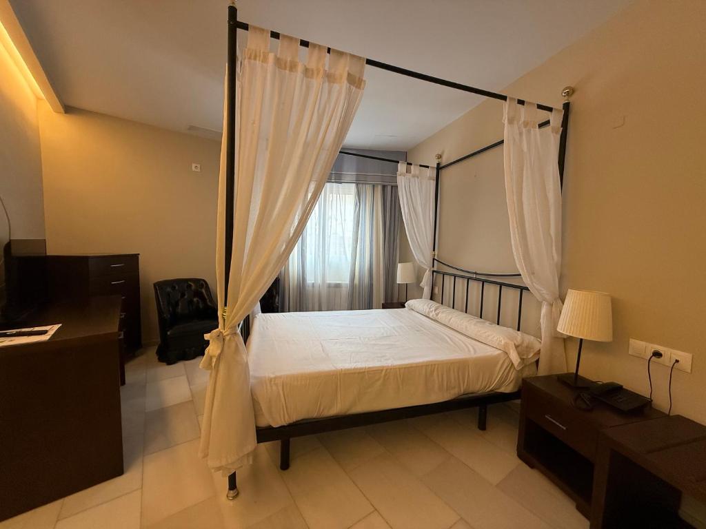 Postel nebo postele na pokoji v ubytování Hotel Nuevo Palas