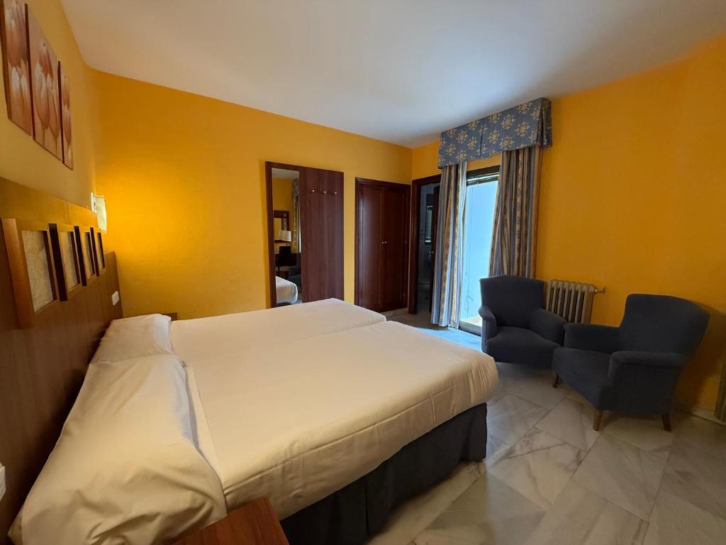 Postel nebo postele na pokoji v ubytování Hotel Nuevo Palas