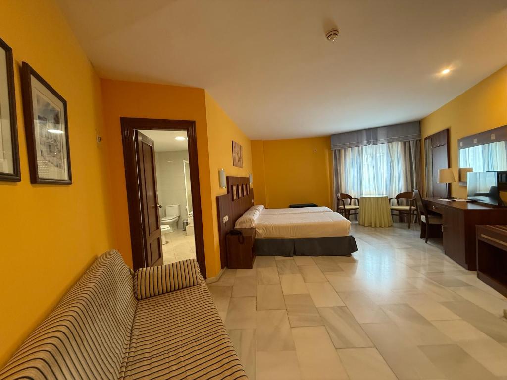 Postel nebo postele na pokoji v ubytování Hotel Nuevo Palas