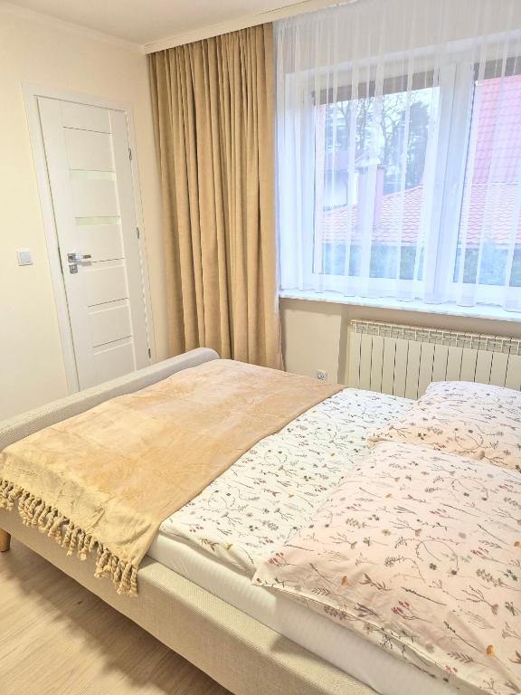 Postel nebo postele na pokoji v ubytování Villa Joanna