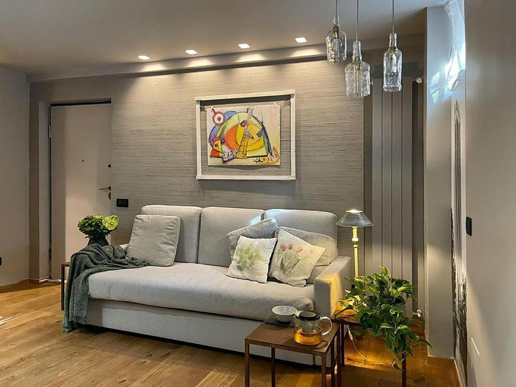 a living room with a couch and a table at Luxury Artistic & Design Apartment in Historic Center, with Chromotherapy & Private Parking, Navigli - Bocconi in Milan