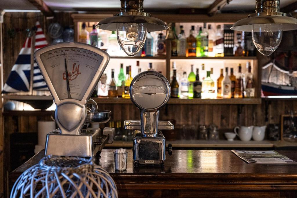 a bar with a mirror on top of a counter at Hotel Puerto Arnela in Camariñas