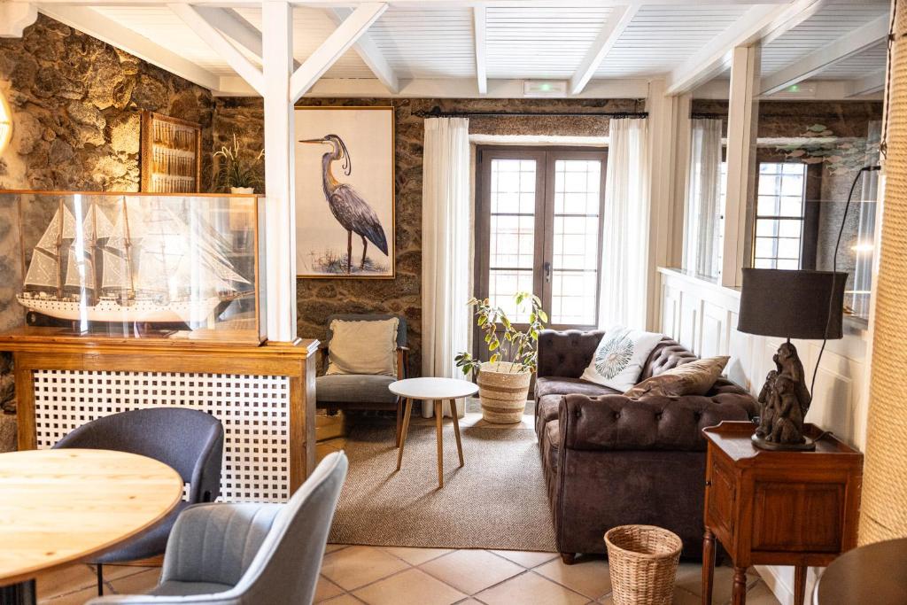 a living room with a couch and a table at Hotel Puerto Arnela in Camariñas
