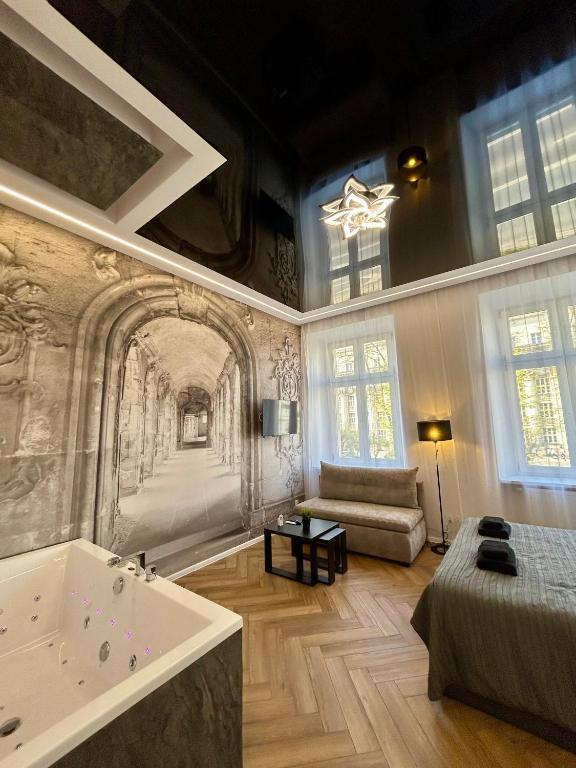 a large room with a bath tub and a bed at Sky Mirror jacuzzi in Krakow