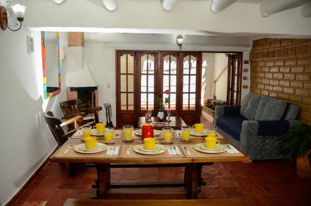 a living room with a table with cups and drinks on it at La CASITA BOUTIQUE VILLA DE LEYVA in Villa de Leyva