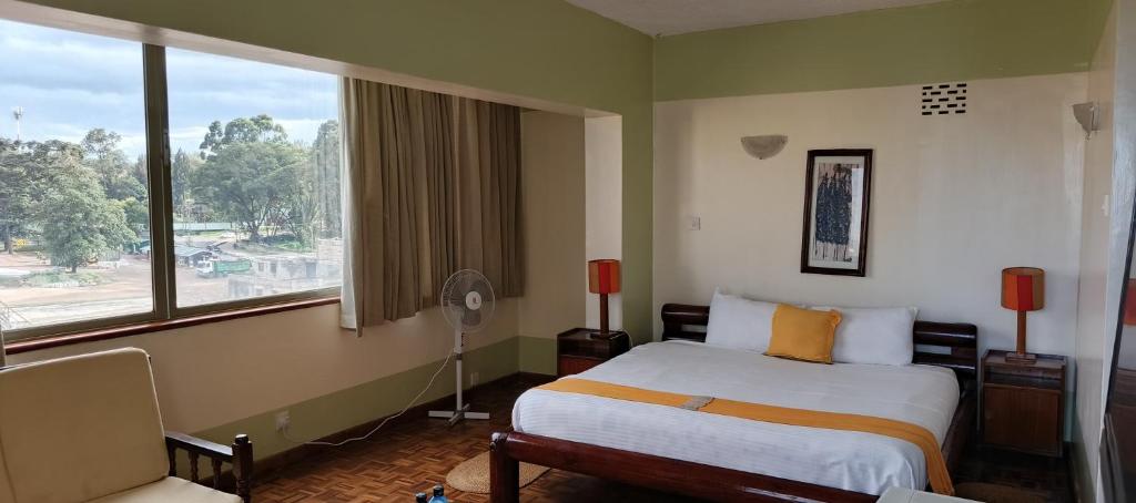 Postel nebo postele na pokoji v ubytování Kenya Comfort Suites